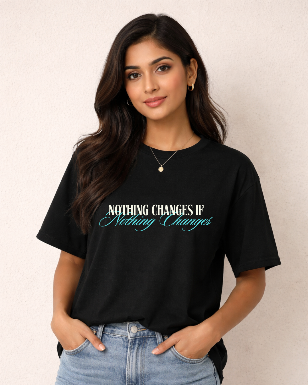 Woman wearing a black t-shirt with text on a plain background