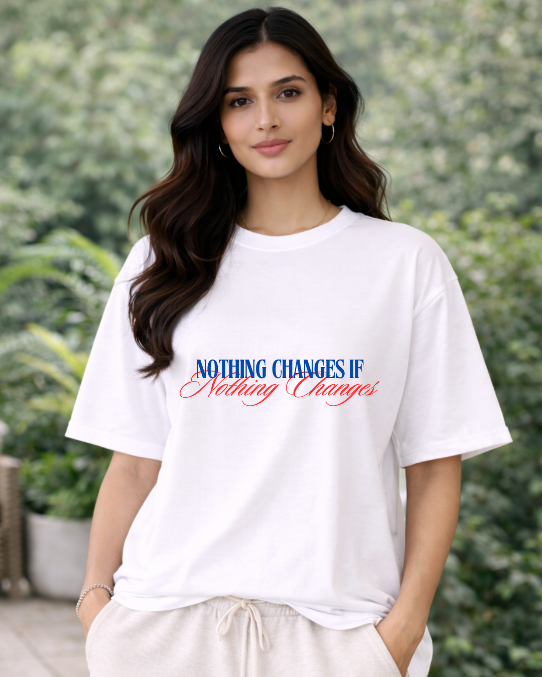 Woman wearing a white t-shirt with a motivational quote outdoors